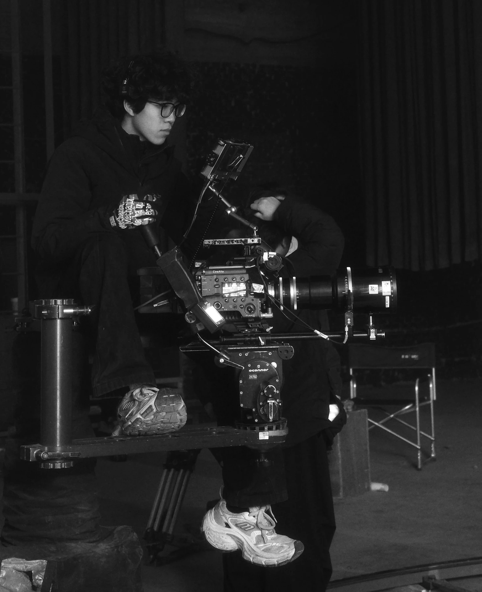 Jing Li working with a cinema camera on set